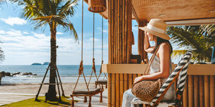 Woman sitting by a tropical beach